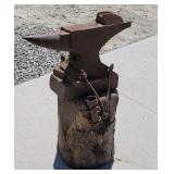 154 pound anvil on log