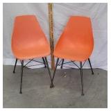 2 orange mid century chairs
