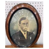 Portrait of a man in bowed glass frame approx