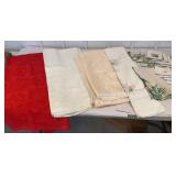 Box of lace tablecloths and embroidered runners