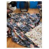 Black mesh laundry bag with floral comforter and