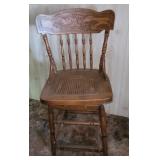 Swivel press back bar stool.