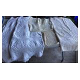 Box of linens - single quilts, tablecloths and