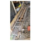 Lumber and wooden ladder