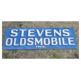 OLD Stevens Oldsmobile sign, on masonite, 21x66.