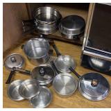 stainless pots and pans in cupboard - clean