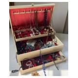 Cream colored jewelry box with jewelry