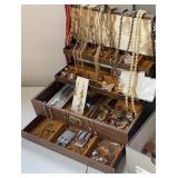 Brown jewelry box full of contents