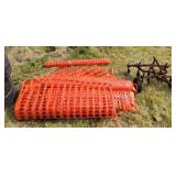 Large pile of snow fence rolls.