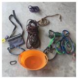 Orange tote of leashes, collars, bungee cords