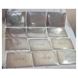 12 monogrammed "LHR" cork backed pewter? mats