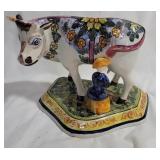 Old Delft cow being milked statue - horns damaged