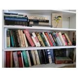 Contents of single white bookshelf hanging over