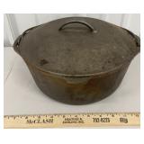 Heavy lidded cast iron Dutch oven