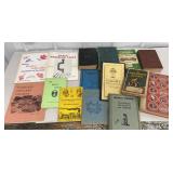 Box of books and collector guides and menu from