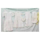 2 dresses, slip, 2 aprons, bonnet