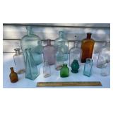 Old colorful bottles in a small clear tote