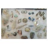 Lot of sparkly jewelry, stone pennants, etc