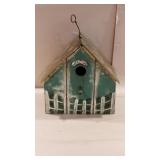 Wooden bird house with copper roof