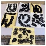 Clear container of antique black beaded trim