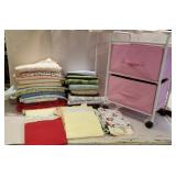 Lot of flannel fabric in a roll cart,