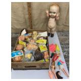 Box of vintage doll parts, kewpie etc