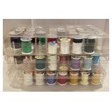 3 plastic containers with spools of thread