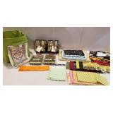 Green tote of fabric, packs of quilt works,