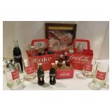 Collection of Coca-Cola bottles and carrier,