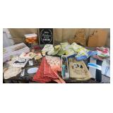 Clear tub full of NICE new kitchen towels,