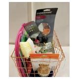 Copper basket filled with kitchen utensils,