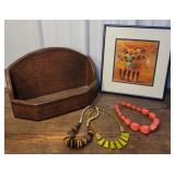 African? Print, chunky necklaces, and wicker wall