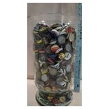 Huge vase full of different beer/soda caps