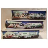 3 Hess trucks, 2 with cars,