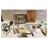 Kitchen items, silverware, knifes, cutting board,