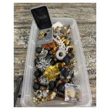 Clear tub of fashion jewelry