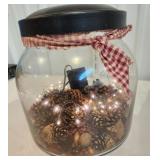 Large jar with pinecones and light smells nice