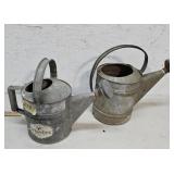 2 galvanized watering cans