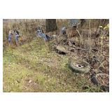 Scrap pile in woods, plows, snowmobile