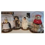 4 dolls under glass domes