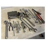 lot of wrenches and sockets, pipe wrench