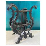 Cast lyre magazine rack