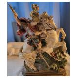 Saint George slaying dragon statue.