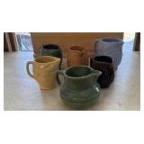 6 Pottery pitchers  multiple colors.