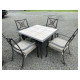 Outdoor tile top table with four chairs and