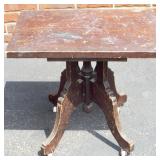 Victorian dark wood small table with wheels.