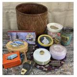 Basket with candy tins, dusting powder cases,