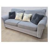 Blue sofa with throw pillows from clean house