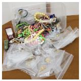 Small tub of costume jewelry, pins, necklaces,