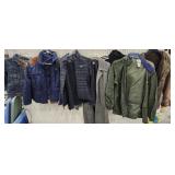 Green tub of coats and jackets - Nike, Adidas, etc